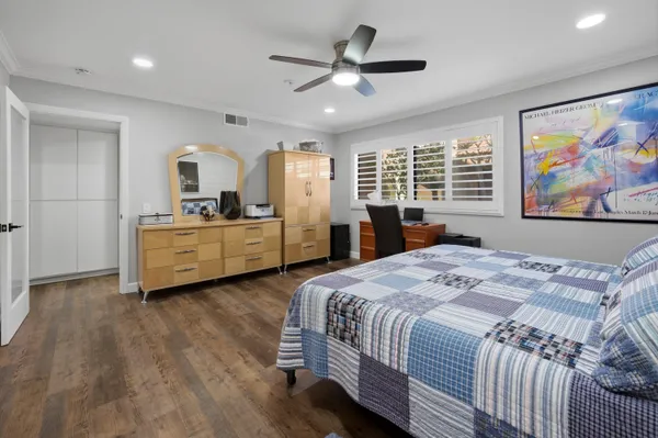a bed room with a bed and a large window