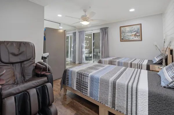 a bedroom with bed and wooden floor