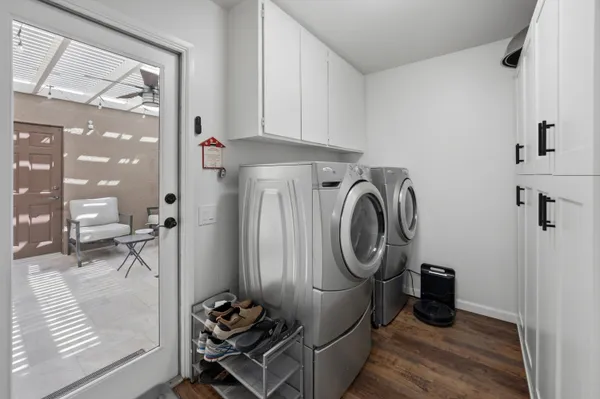 a utility room with sink dryer and washer
