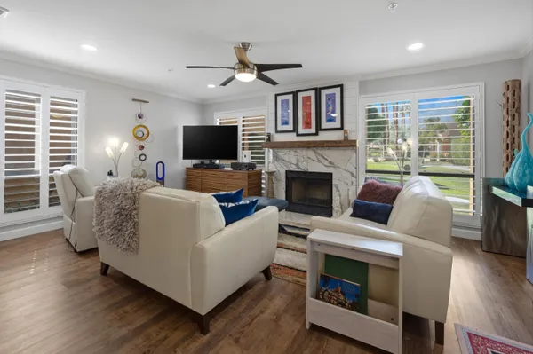 a living room with furniture fireplace and a flat screen tv
