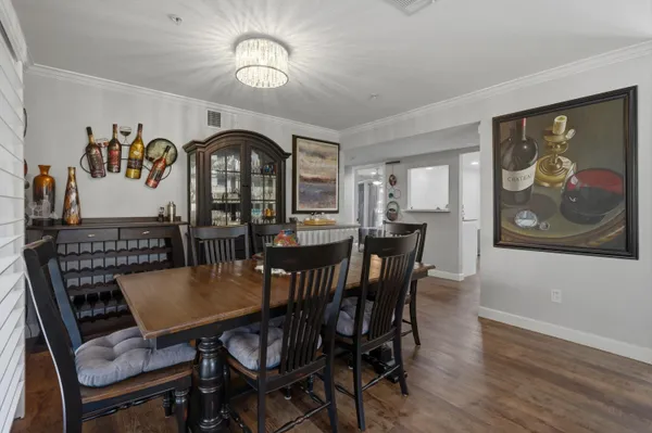 a view of a dining room with furniture wooden floor and a chandelier