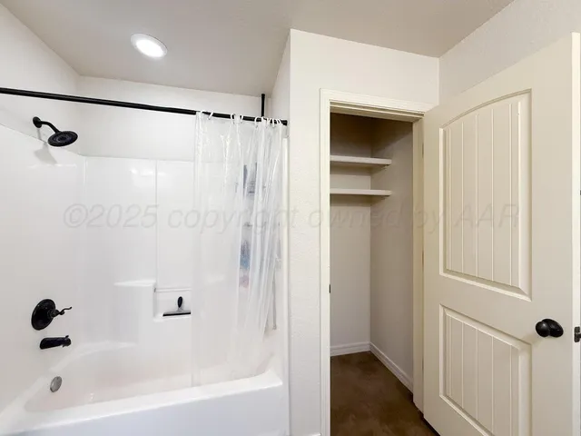 a bathroom with a shower and a tub