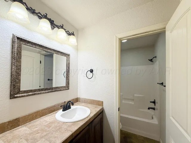 a bathroom with a sink vanity and a mirror