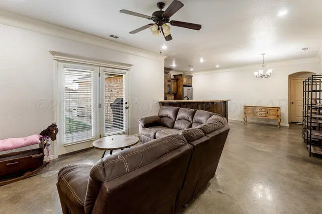 a living room with furniture and a chandelier