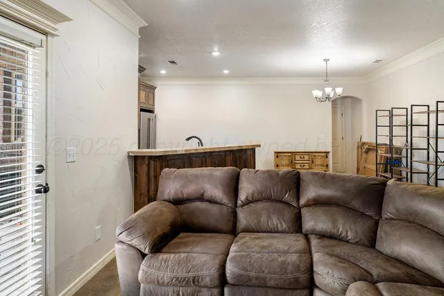 a living room with furniture a chandelier and a couch