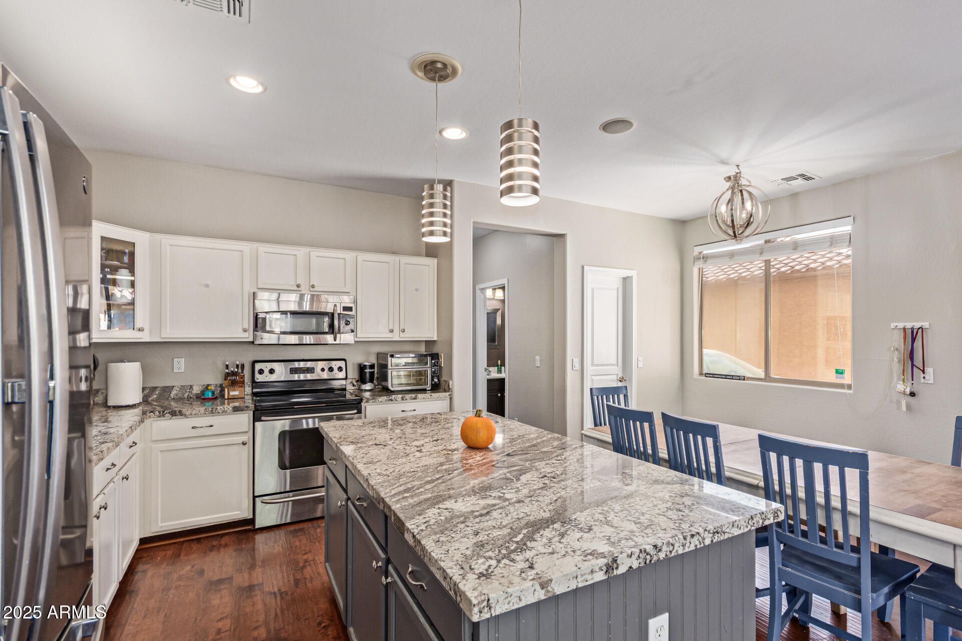 3802 East Chickadee Road Gilbert, AZ 85297 - Photo 10 of 29 a kitchen with stainless steel appliances granite countertop a sink stove and refrigerator