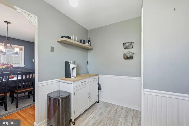 a room with a baby crib and a wooden floor