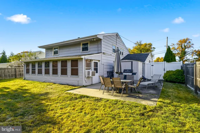 a view of a house with swimming pool and sitting area
