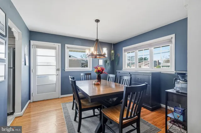 a dining room with furniture a chandelier and window