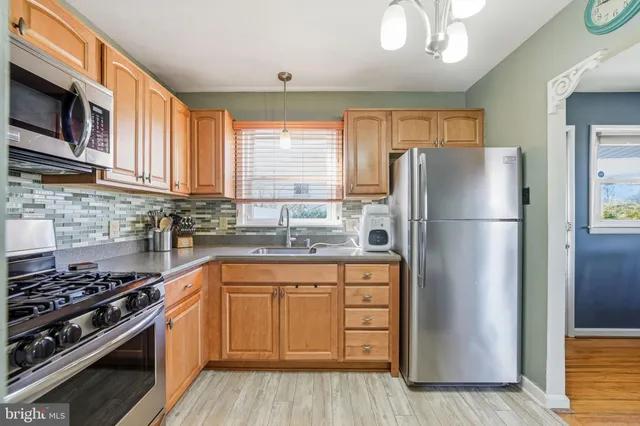 a kitchen with a refrigerator stove and sink