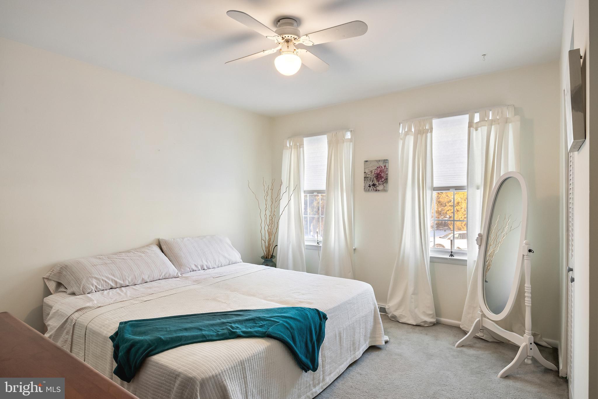 1 Echo Avenue Moorestown, NJ 08057 - Photo 22 of 30 a bedroom with a bed and a chandelier