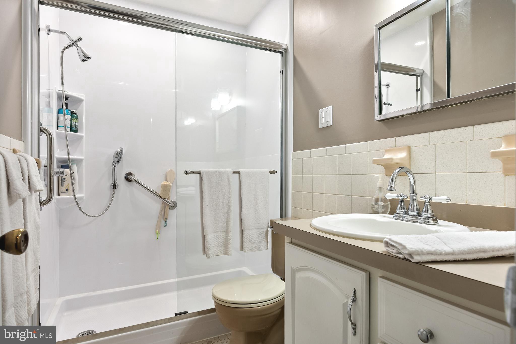 1 Echo Avenue Moorestown, NJ 08057 - Photo 24 of 30 a bathroom with a granite countertop sink a toilet and a mirror