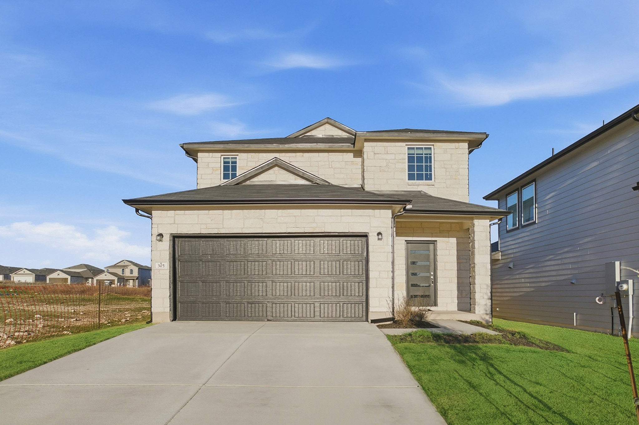 a front view of a house with a yard