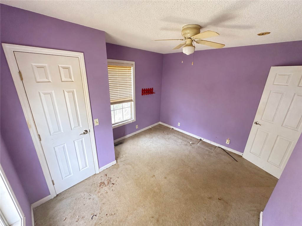 138 Cloverdale Road Seneca, SC 29678 - Photo 17 of 27 A quiet bedroom featuring a ceiling fan, ready for a personalized touch.