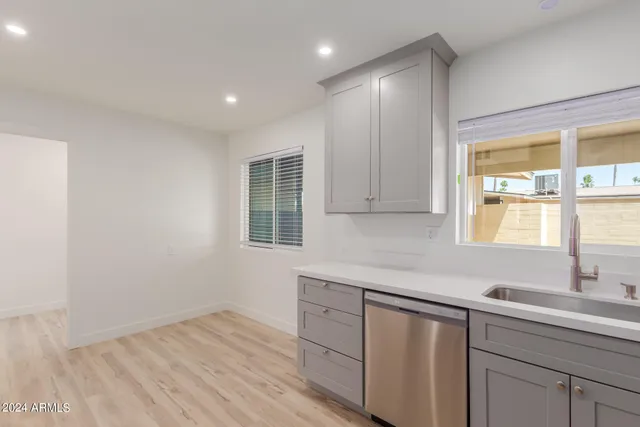 a kitchen with a sink cabinets and window