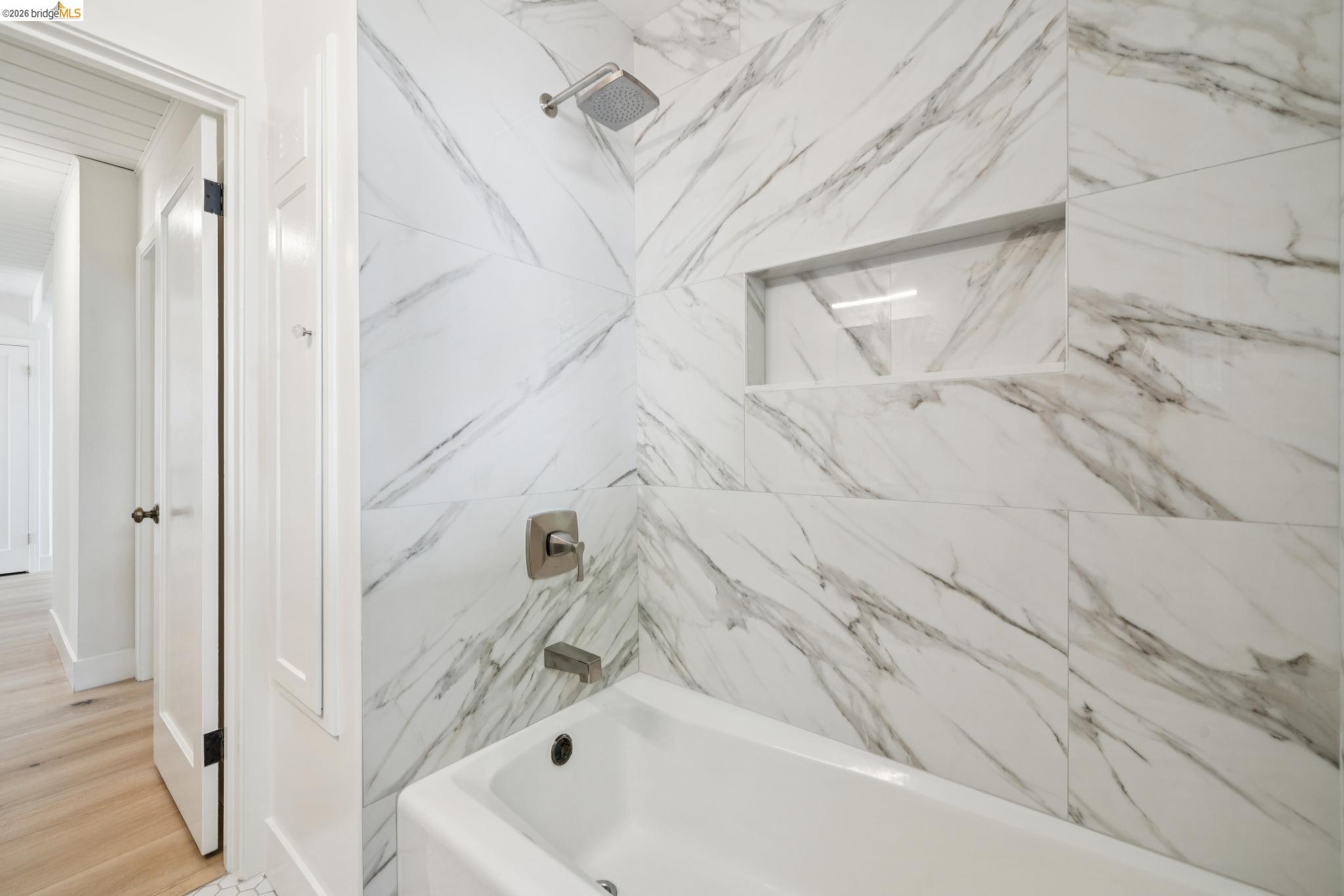 1321 Sunset Loop Lafayette, CA 94549 - Photo 24 of 49 Bathtub with integrated shower, tiled surround with recessed niche, and brushed nickel fixtures