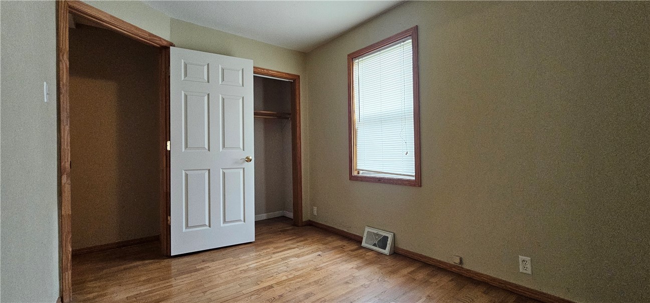 206 East Fifth Street St. Peter, IL 62880 - Photo 16 of 23 an empty room with wooden floor and windows