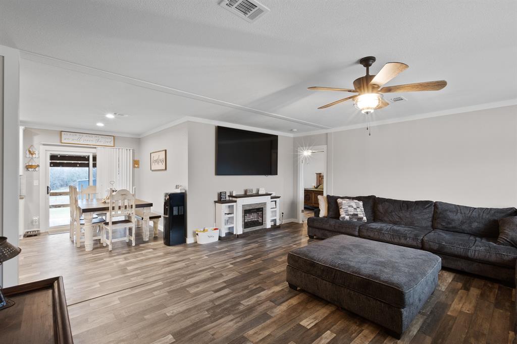 1012 County Road 1180 Decatur, TX 76234 - Photo 11 of 34 a living room with furniture fireplace and a flat screen tv