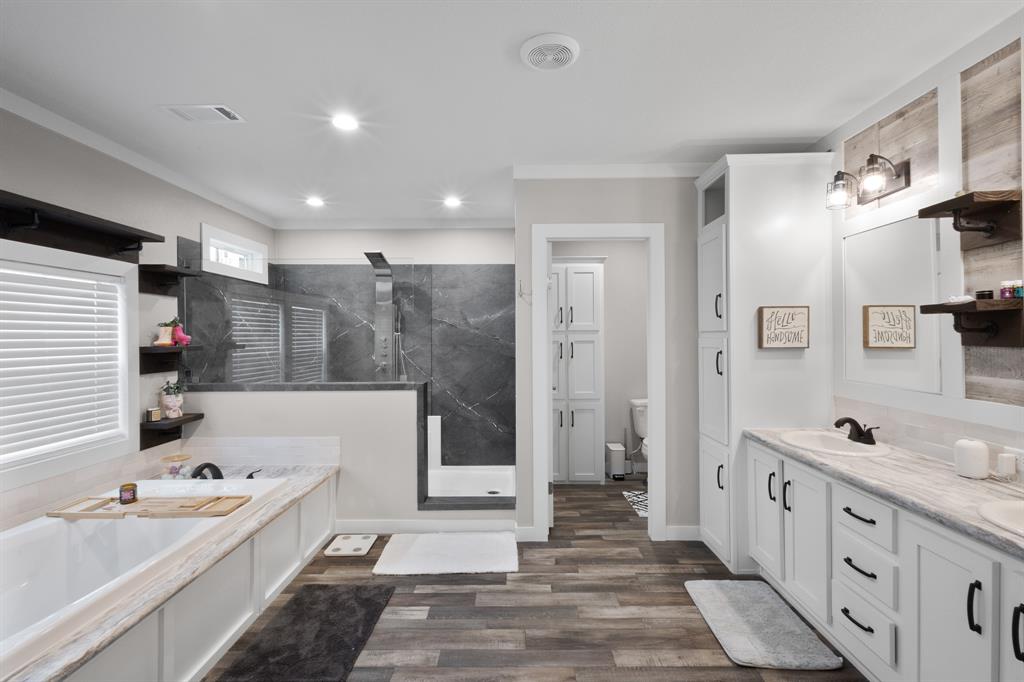 1012 County Road 1180 Decatur, TX 76234 - Photo 15 of 34 a bathroom with a tub sink and mirror