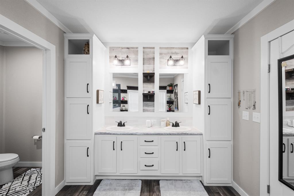 1012 County Road 1180 Decatur, TX 76234 - Photo 16 of 34 a bathroom with a sink and a mirror