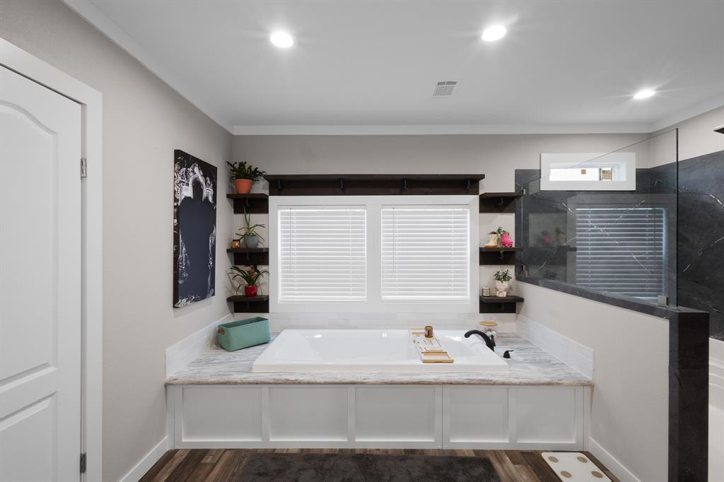 1012 County Road 1180 Decatur, TX 76234 - Photo 18 of 34 a bathroom with a bathtub sink and mirror