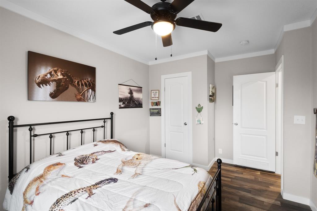 1012 County Road 1180 Decatur, TX 76234 - Photo 22 of 34 a bedroom with a bed and a chandelier