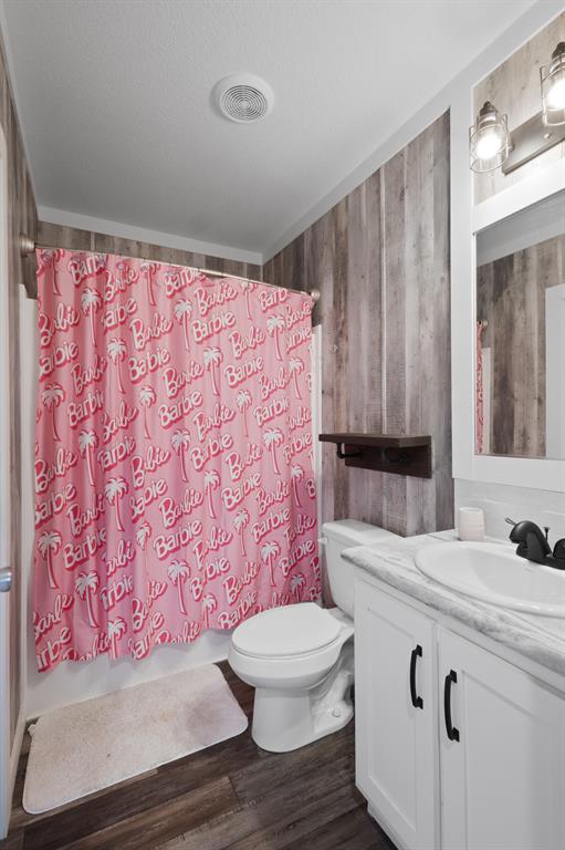1012 County Road 1180 Decatur, TX 76234 - Photo 25 of 34 a bathroom with a sink a toilet a mirror and shower curtain