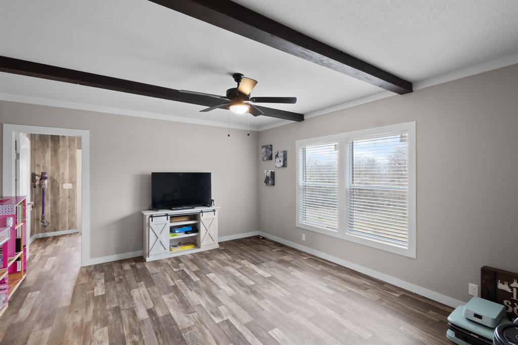 1012 County Road 1180 Decatur, TX 76234 - Photo 26 of 34 a view of livingroom with hardwood floor and a ceiling fan