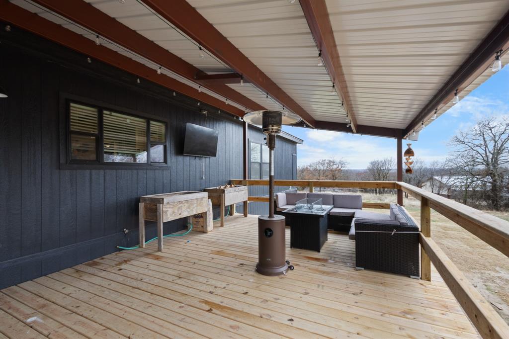 1012 County Road 1180 Decatur, TX 76234 - Photo 30 of 34 a view of a balcony with chairs and wooden floor