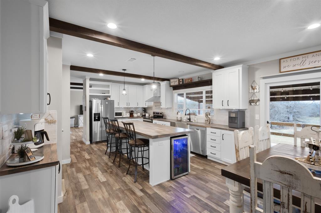1012 County Road 1180 Decatur, TX 76234 - Photo 4 of 34 a kitchen with stainless steel appliances granite countertop a sink stove and refrigerator