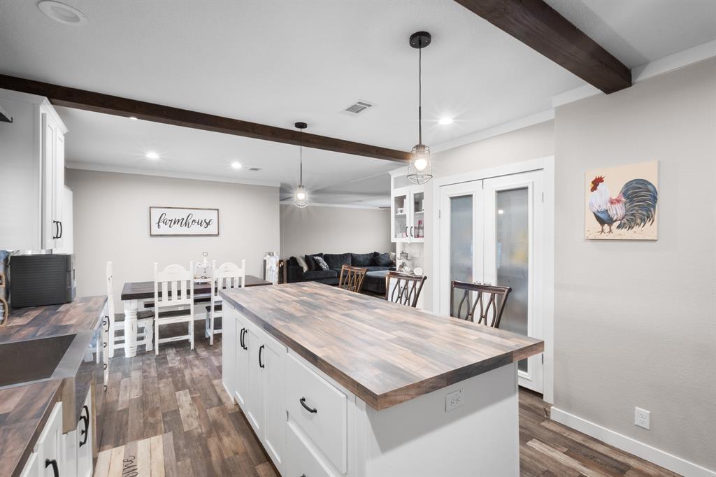 1012 County Road 1180 Decatur, TX 76234 - Photo 6 of 34 a large kitchen with a table and chairs