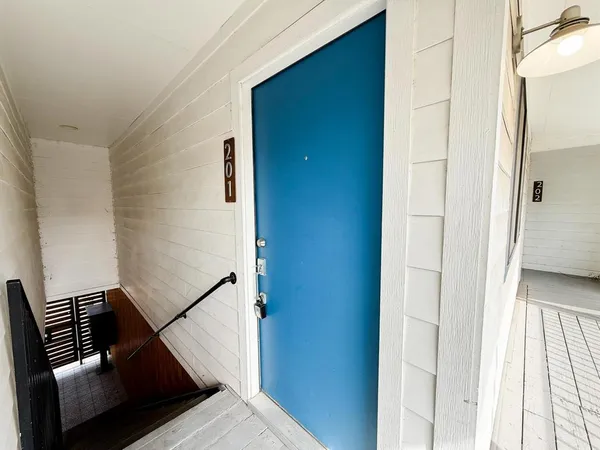 a view of an entryway with wooden floor