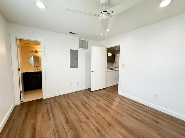 wooden floor in an empty room with a window