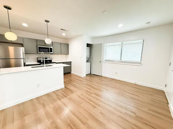 a kitchen with kitchen island a sink stainless steel appliances and cabinets