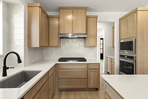 a kitchen with a sink stove and refrigerator