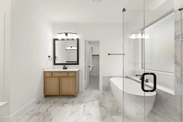 a view of a hallway with a sink and a mirror