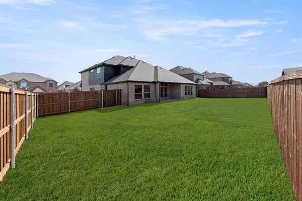 a view of a house with a big yard and large trees
