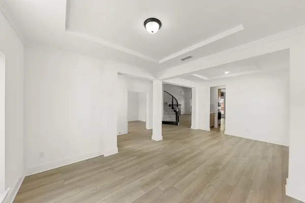 a view of an empty room with wooden floor