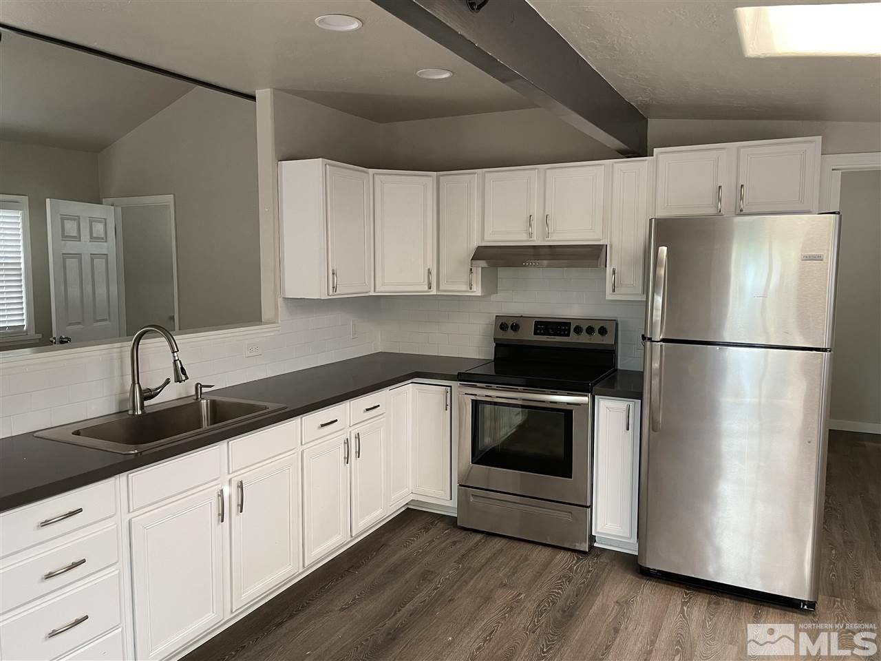 236 Wonder Street Reno, NV 89502 - Photo 4 of 8 a kitchen with a refrigerator and a sink