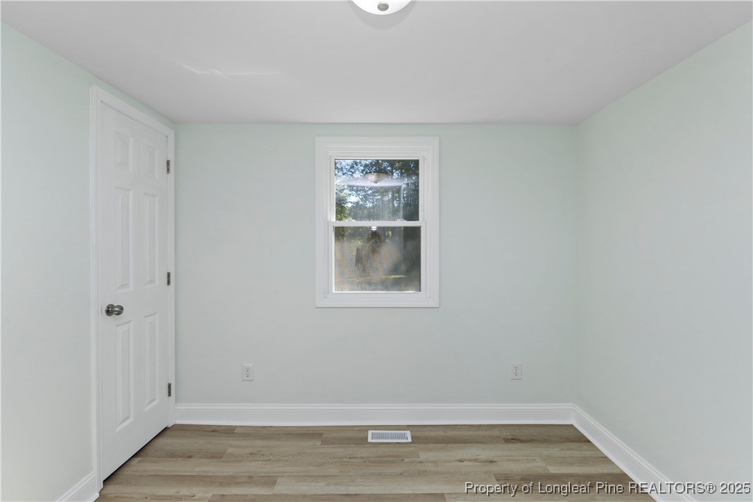 1340 George Perry Lee Road Dunn, NC 28334 - Photo 30 of 31 a view of room with window and hardwood floor
