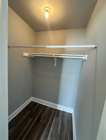 a view of a room with wooden floor