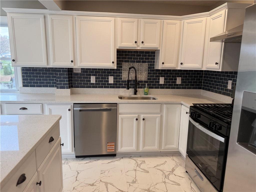 2026 Marshall Road Monaca, PA 15061 - Photo 12 of 30 a kitchen with a sink stove and cabinets