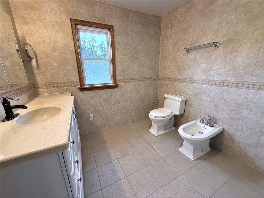 2026 Marshall Road Monaca, PA 15061 - Photo 18 of 30 a bathroom with a toilet a sink and mirror