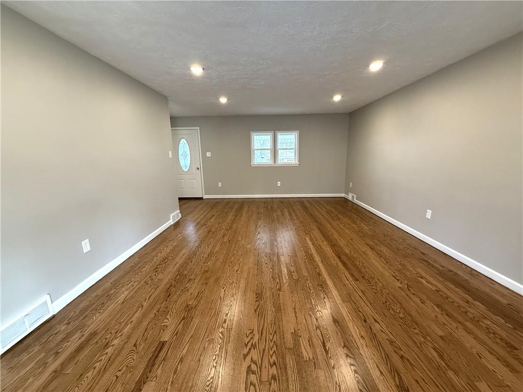 2026 Marshall Road Monaca, PA 15061 - Photo 21 of 30 an empty room with wooden floor and windows