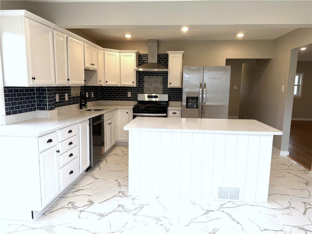 2026 Marshall Road Monaca, PA 15061 - Photo 23 of 30 a kitchen with granite countertop a sink a stove a refrigerator a washer and dryer