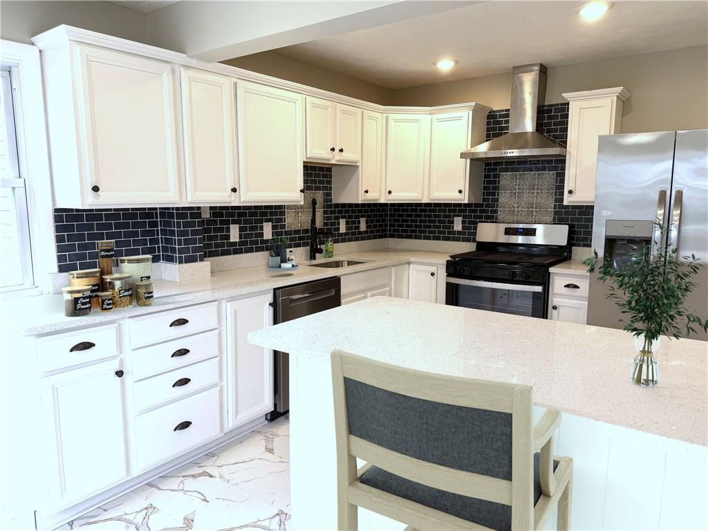 2026 Marshall Road Monaca, PA 15061 - Photo 8 of 30 a kitchen with granite countertop white cabinets and stainless steel appliances