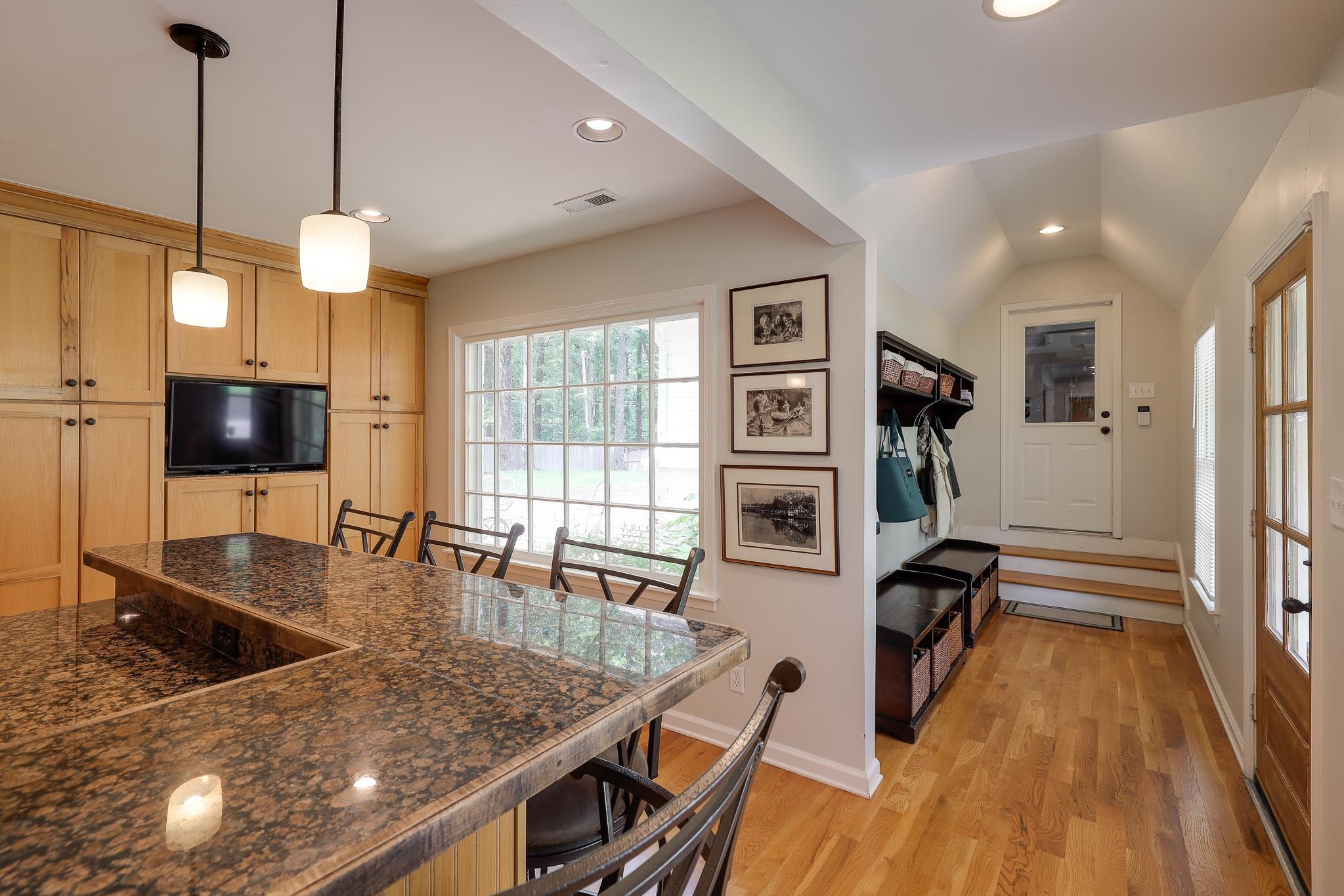 6164 Harwick Drive Memphis, TN 38119 - Photo 16 of 29 a kitchen with stainless steel appliances granite countertop a stove oven and a dining table with wooden floor