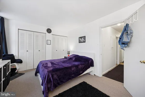 a spacious bedroom with a bed and a walk in closet