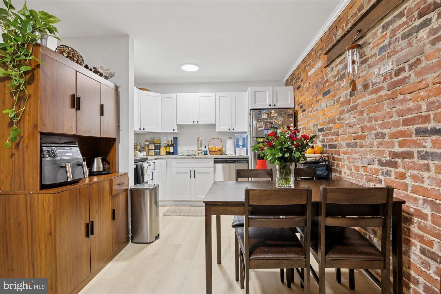1228 South 2nd Street Philadelphia, PA 19147 - Photo 15 of 35 a kitchen with stainless steel appliances kitchen island granite countertop a table and chairs in it