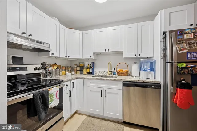 a kitchen with granite countertop stainless steel appliances and cabinets
